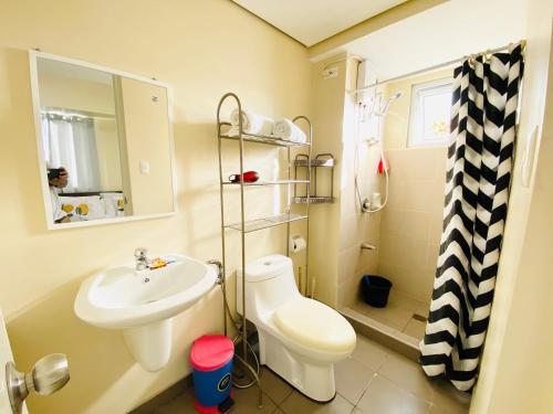 a small bathroom with a sink and a toilet at Cebu Avida Riala by P&J in Cebu City