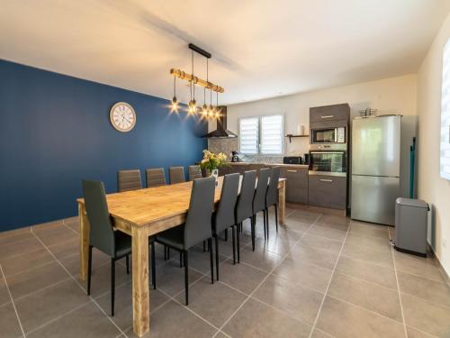 a kitchen and dining room with a wooden table and chairs at Gite 6 personnes in Vesseaux