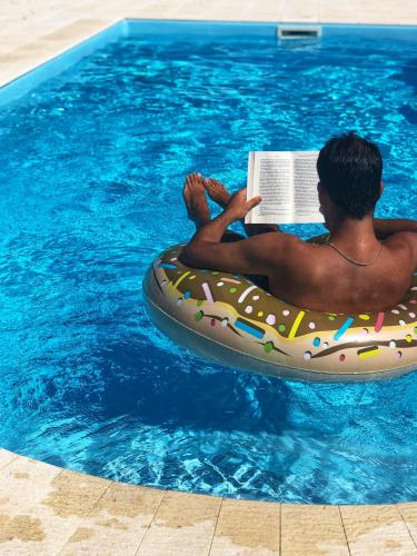 a man laying on an inflatablelatable at A Casa do Soito in Oliveira do Hospital