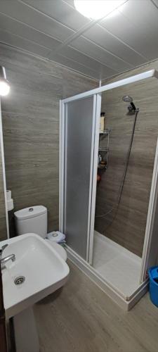 a bathroom with a shower and a toilet and a sink at Sunny Room in Habitat in Maspalomas