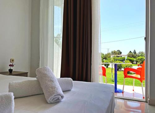 a bedroom with a bed and a view of a patio at Villa Maroula in Afantou