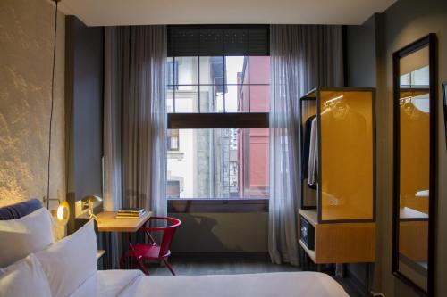 a hotel room with a bed and a window at Letoh Letoh San Sebastián in San Sebastián
