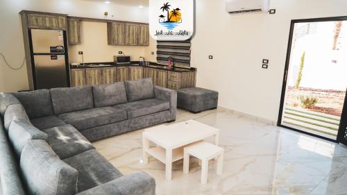 a living room with a couch and a table at The palm heaven chalets in Jerash