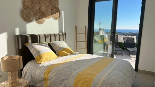 a bedroom with a bed with a view of a balcony at Polop Hills 21A by Bookaparadise in Polop