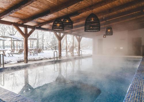 a swimming pool with steam coming out of it at Elisefarm in Fogdarp