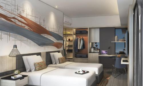a living room with two beds and a kitchen at Citadines Bacolod City in Bacolod