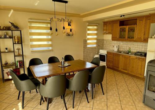 a kitchen with a wooden table and chairs at Tribistovo Holiday House in Posušje