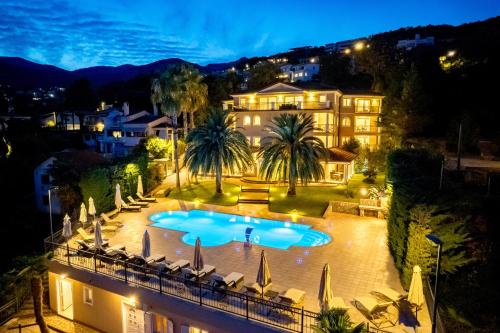 a large swimming pool in front of a house at night at Villa Perla Apartments with balcony in Ičići