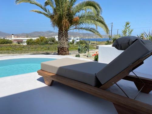 a bed sitting on a deck next to a swimming pool at Kostantakis Residence & Winery in Pollonia