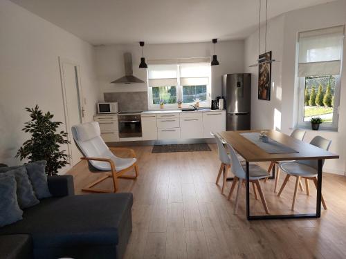 a kitchen and living room with a table and chairs at Holiday Home Mierki 2 in Olsztynek