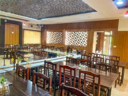 a restaurant with tables and chairs in a room at Narayans Leela Inn in Udaipur