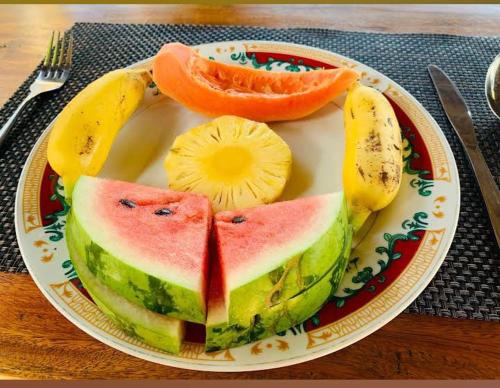 a plate of fruit on a table with a plateasteryasteryasteryasteryasteryastery at Evi's Place in Galle