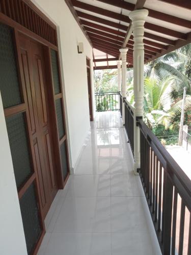 a corridor of a house with a wooden door at Evi's Place in Galle