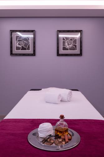 a tray with a plate of food on a bed at Vila Gale Evora in Évora