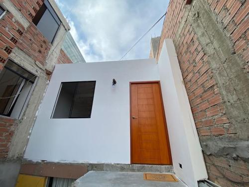 a building with a brown door on the side of it at Modern Apartment close to the airport ,Malls and beach in Lima