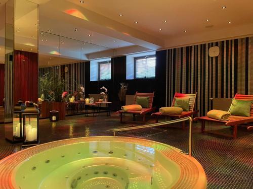 a large room with a jacuzzi tub in a hotel at Hotel Yasmin Košice in Košice