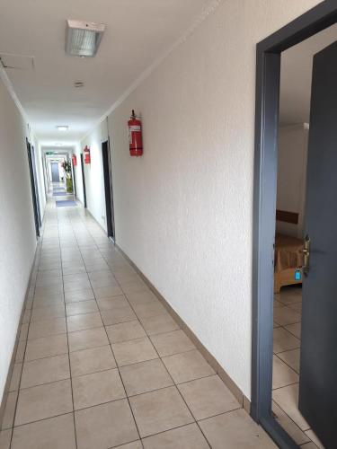 an empty hallway with a fire extinguisher on the wall at Pensiunea Vila Chesa in Corunca