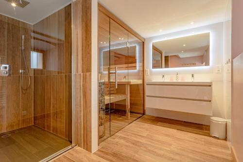 a bathroom with a shower and a sink at Chalet Marijo: Sauna & Charme Alpin in Saint-Marcel