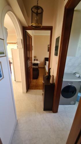 a hallway with a bathroom with a sink and a mirror at stratigato in Chios