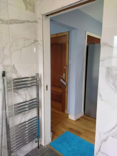a room with a hallway with a door and a mirror at Double Ensuite room, 1-minute walk to bus stop in Edinburgh