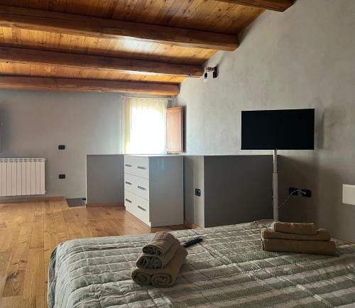 a bedroom with a bed with a flat screen tv at Sardinia Costa Ovest in Càbras