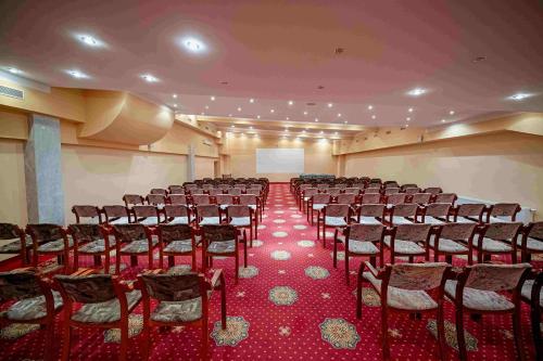 a large room with rows of chairs and a screen at Hotel Gołębiewski Białystok in Białystok