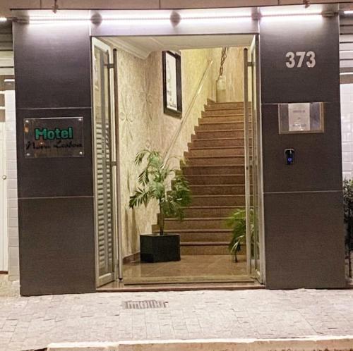 an open door to a building with a staircase at Hotel Nova Lisboa - Adult Only- in Sao Paulo