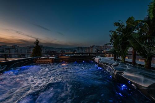 a swimming pool with a water slide at night at The Episode - Jacuzzi Penthouses in Cluj-Napoca