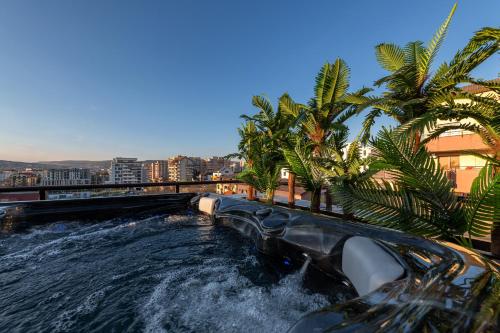 a water slide in a city with palm trees at The Episode - Jacuzzi Penthouses in Cluj-Napoca