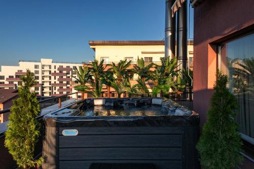 a hot tub on the balcony of a building at The Episode - Jacuzzi Penthouses in Cluj-Napoca
