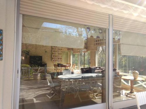 une porte en verre du salon avec une table dans l'établissement Splendid Villa in the heart of Deauville, à Deauville