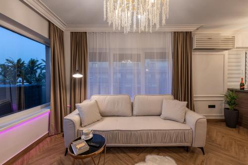 a living room with a couch and a large window at The Episode - Jacuzzi Penthouses in Cluj-Napoca