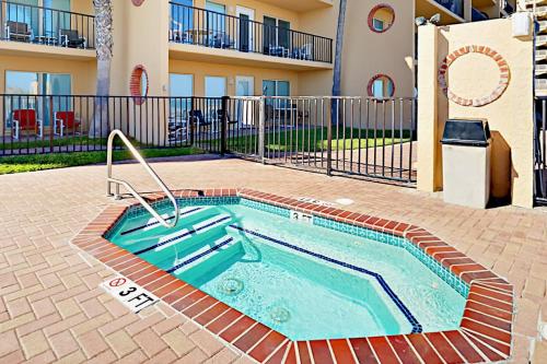 a swimming pool in the courtyard of a apartment at Suntide II in South Padre Island