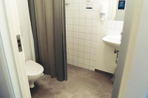 a bathroom with a toilet and a sink at Danhostel Aarhus City in Aarhus