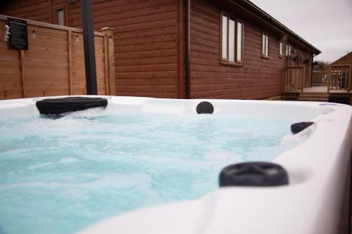 a hot tub in front of a house at 3 Bedroom lodge with hot tub in York