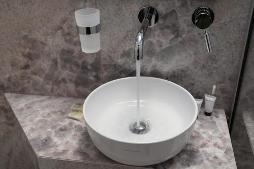 a bathroom with a bowl sink with a faucet at Paradise Hotel in Parga