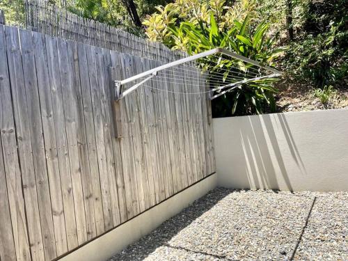 a wooden fence with a metal object on top of it at New Pool Now Open! - Trinity Beach Haven - Luxury 4 bedroom home, Steps to the Beach, Surrounded by Mountains in Trinity Beach