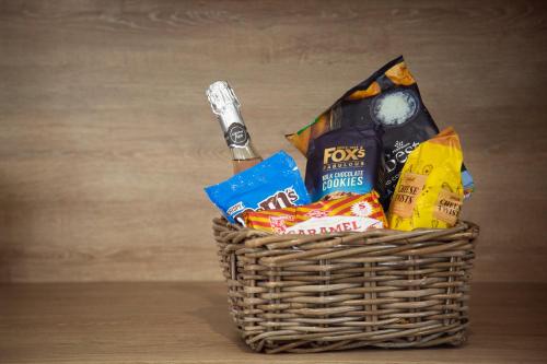 a basket filled with chips and snacks on a table at 3 Bedroom lodge with hot tub in York