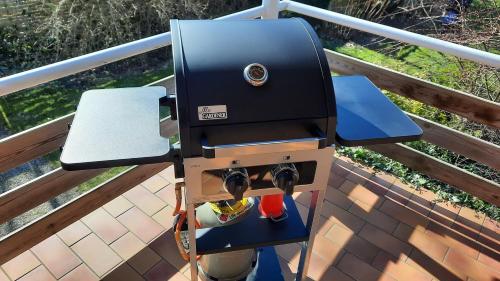 a bbq grill on a deck on a balcony at Haus Hygge - Ferienwohnung Anker in Boren