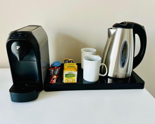 a black tray with a coffee maker and a coffeemaker at The Home by AN in Lapithos