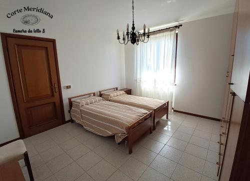 Postel nebo postele na pokoji v ubytování Corte Meridiana