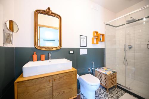 a bathroom with a sink and a toilet and a mirror at ARYA Bed and Breakfast in Roccasecca