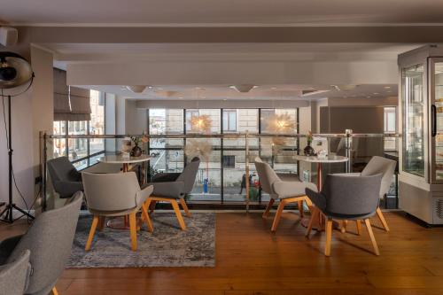 a living room with chairs and a dining room at Grand Hotel Bonavia in Rijeka