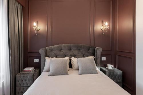 a bedroom with a large bed with two pillows at The Episode - Jacuzzi Penthouses in Cluj-Napoca
