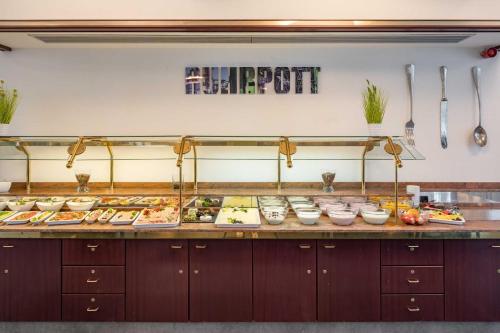 a buffet line with many different types of food at Astoria City Resort in Essen