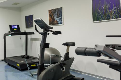 a gym with a treadmill and a exercise bike at Grand Hotel Bonavia in Rijeka