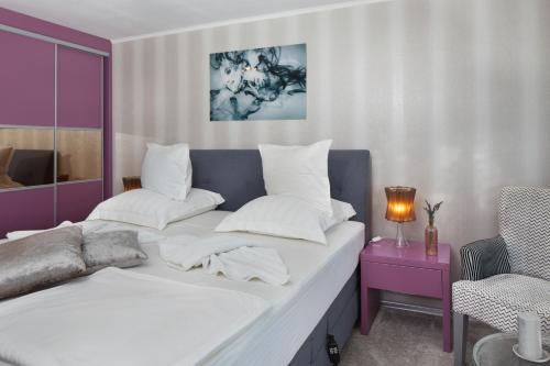 a bedroom with a large bed with white pillows at Villa Elea in Nesebar