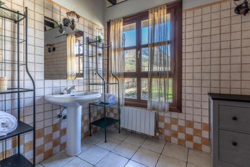 a bathroom with a sink and a window at Caserío Zubieta in Orózqueta