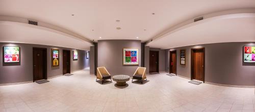 a hallway with chairs and a table in a building at Emirates Sports Hotel, Dubai Sports City in Dubai