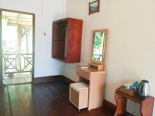 a room with a sink and a cabinet and a mirror at VangVieng Ruby'Homestay in Vang Vieng